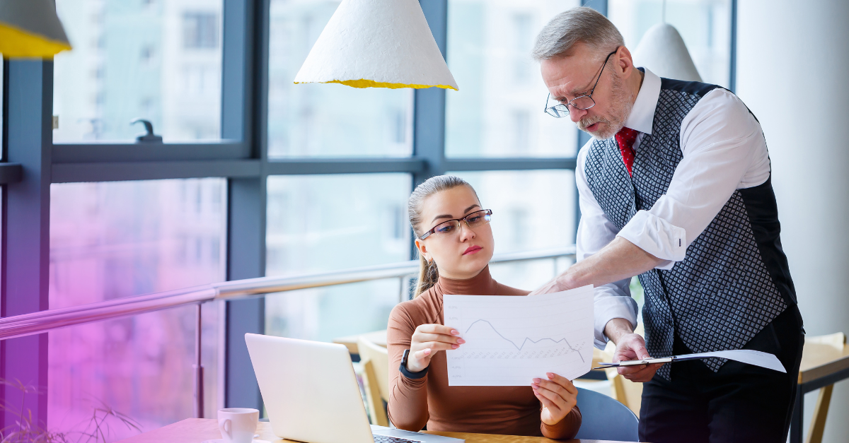 man and woman looking at business plan